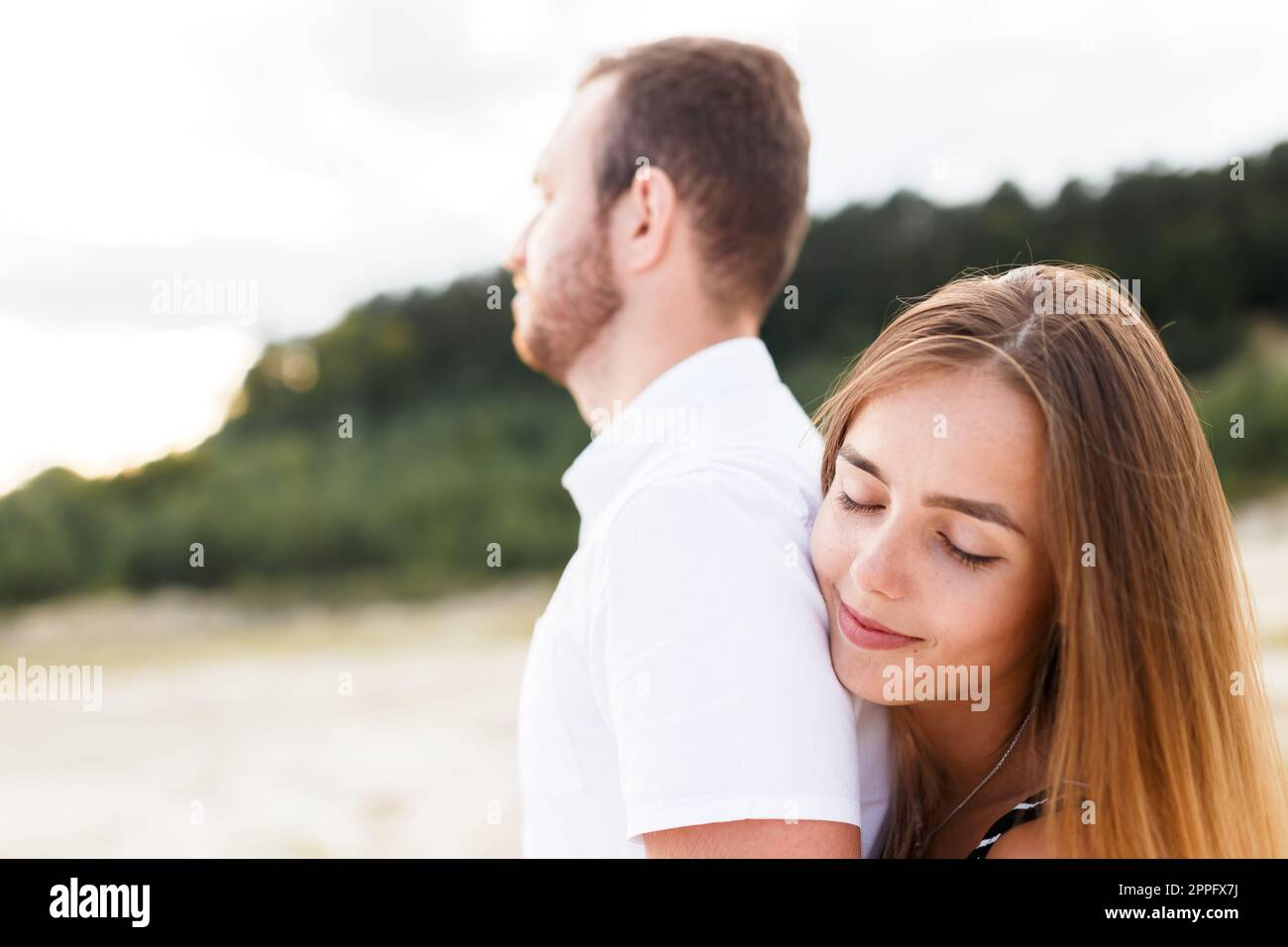 man and a woman are hugging on a sandy beach in summer Stock Photo - Alamy