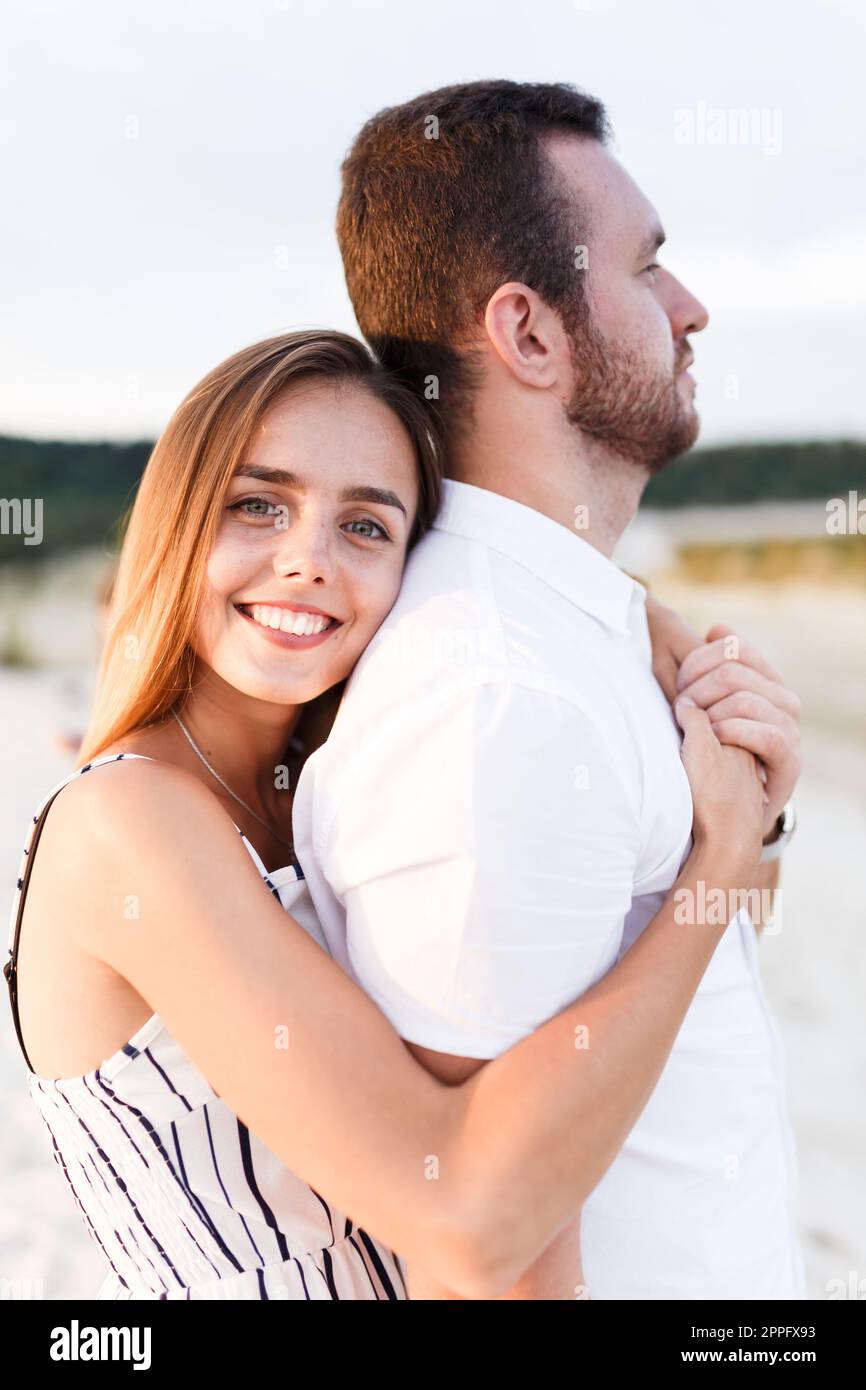 man and a woman are hugging on a sandy beach in summer Stock Photo - Alamy