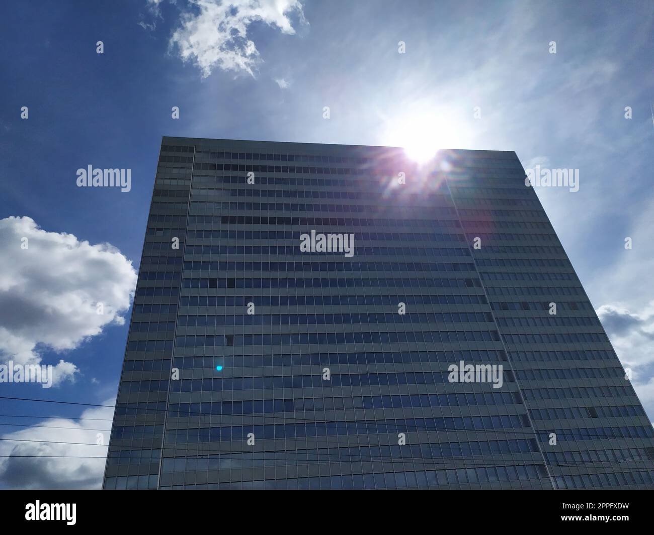 Dusseldorf, Germany - July 16th, 2022: High skyscraper Dreischeibenhaus from Thyssenkrupp in DÃ¼sseldorf as tall building in summer as contemporary architecture and clean glass facade blue sky clouds Stock Photo