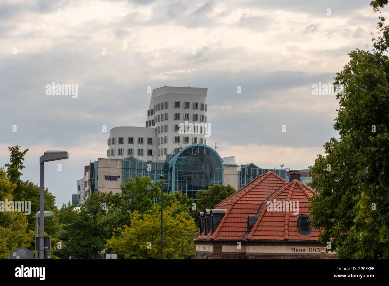 DÃ¼sseldorf, Germany 07 20 2022: WDR Westdeutscher Rundfunk central in Dusseldorf with WDR logo and Ghery buildings in background of Medienhafen Dusseldorf radio broadcasting and television production Stock Photo