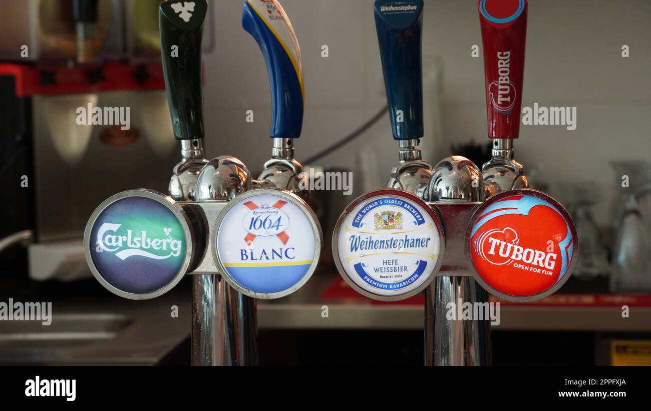 Ein-Bokek, Israel - JULY 6:Bar pumps for dispensing draught beer from the metal storage kegs in a pub or bar. Cranes for bottling beer in a bar Stock Photo