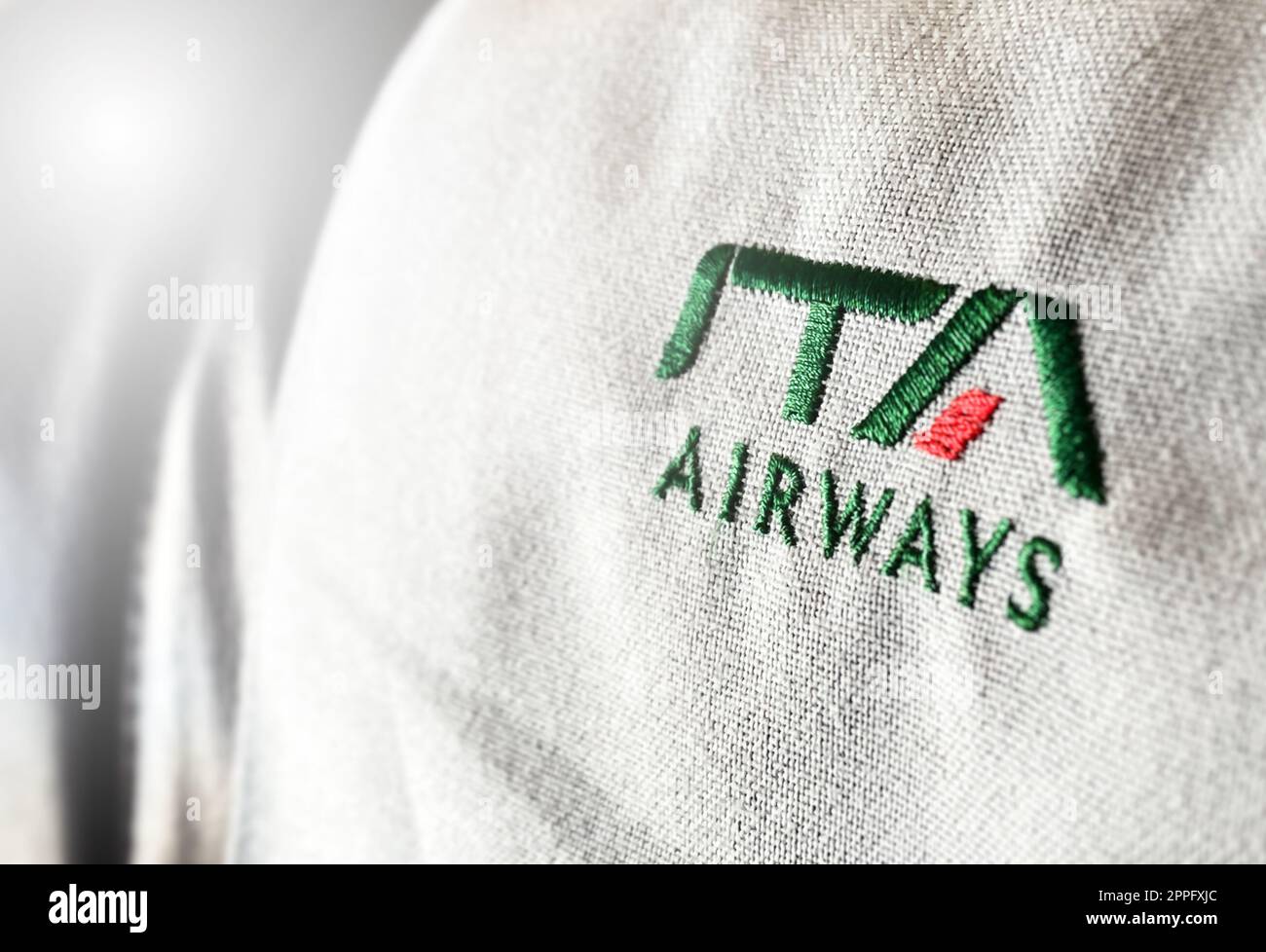 The logo of the airline ITA Airways sewn on the headrest of an aircraft Stock Photo