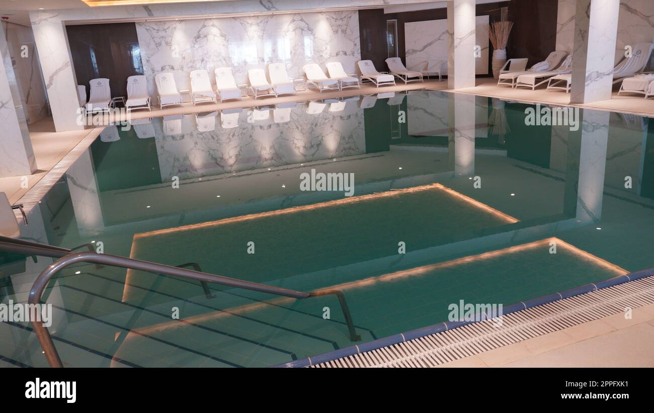 EIN BOKEK, Israel - 6 July 2022: Ein Bokek Spa swimming pool. Indoor pool with mineral salty water in hotel at the Dead Sea resort Israel. Stock Photo