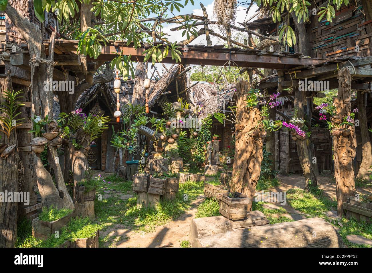 The garden of the Hippie Bar is decorated with flowers, mobiles, sculptures and wind chimes Stock Photo