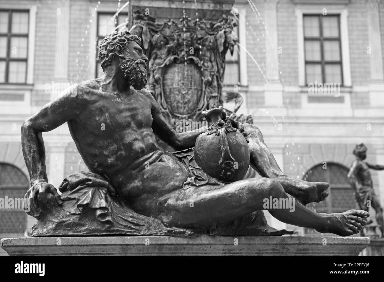 Black and white photo - river god with wine vat at the Wittelsbach fountain residence in Munich Stock Photo