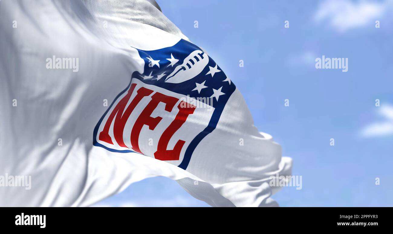 The flag with the NFL logo waving in the wind Stock Photo