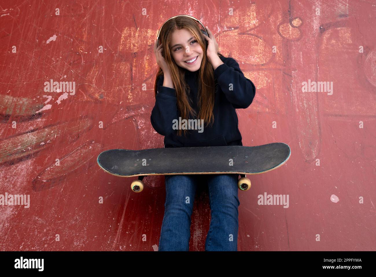 girl listening music with skateboard Stock Photo - Alamy