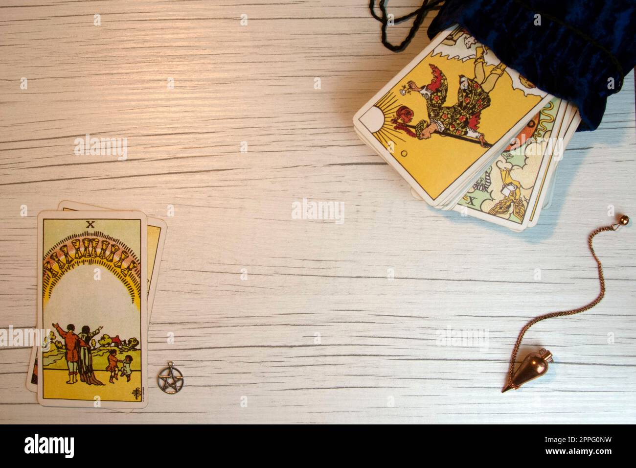 Top view of tarot cards, pentacle and pendulum on white wood Stock Photo
