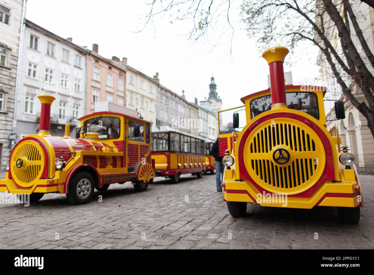 electric eco tourist train in the city of Lviv travels through the streets. Stock Photo