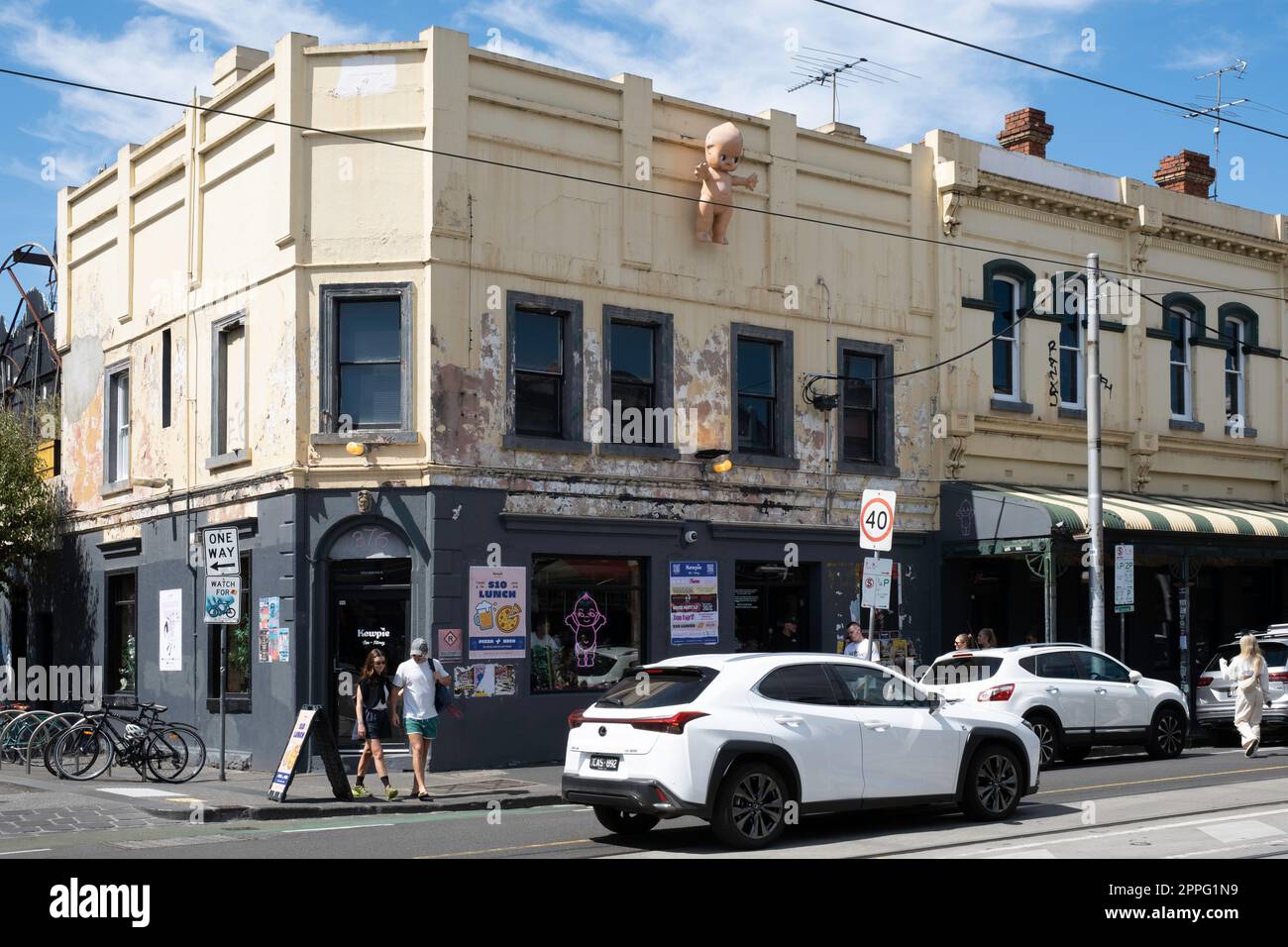Brunswick street in Fitzroy in Melbourne, with the Kewpie restaurant and the giant Kewpie doll on the building's exterior Stock Photo