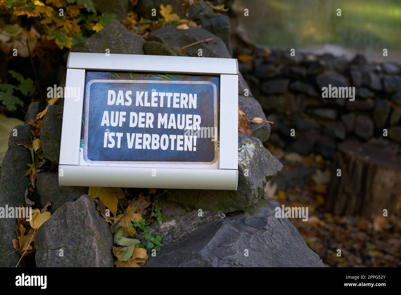 Prohibition sign in a park in Germany. Translation Climbing the wall