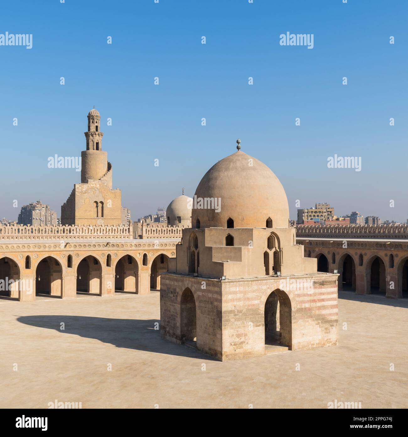 Courtyard of Ibn Tulun public historical mosque with ablution fountain and the minaret, Cairo, Egypt Stock Photo