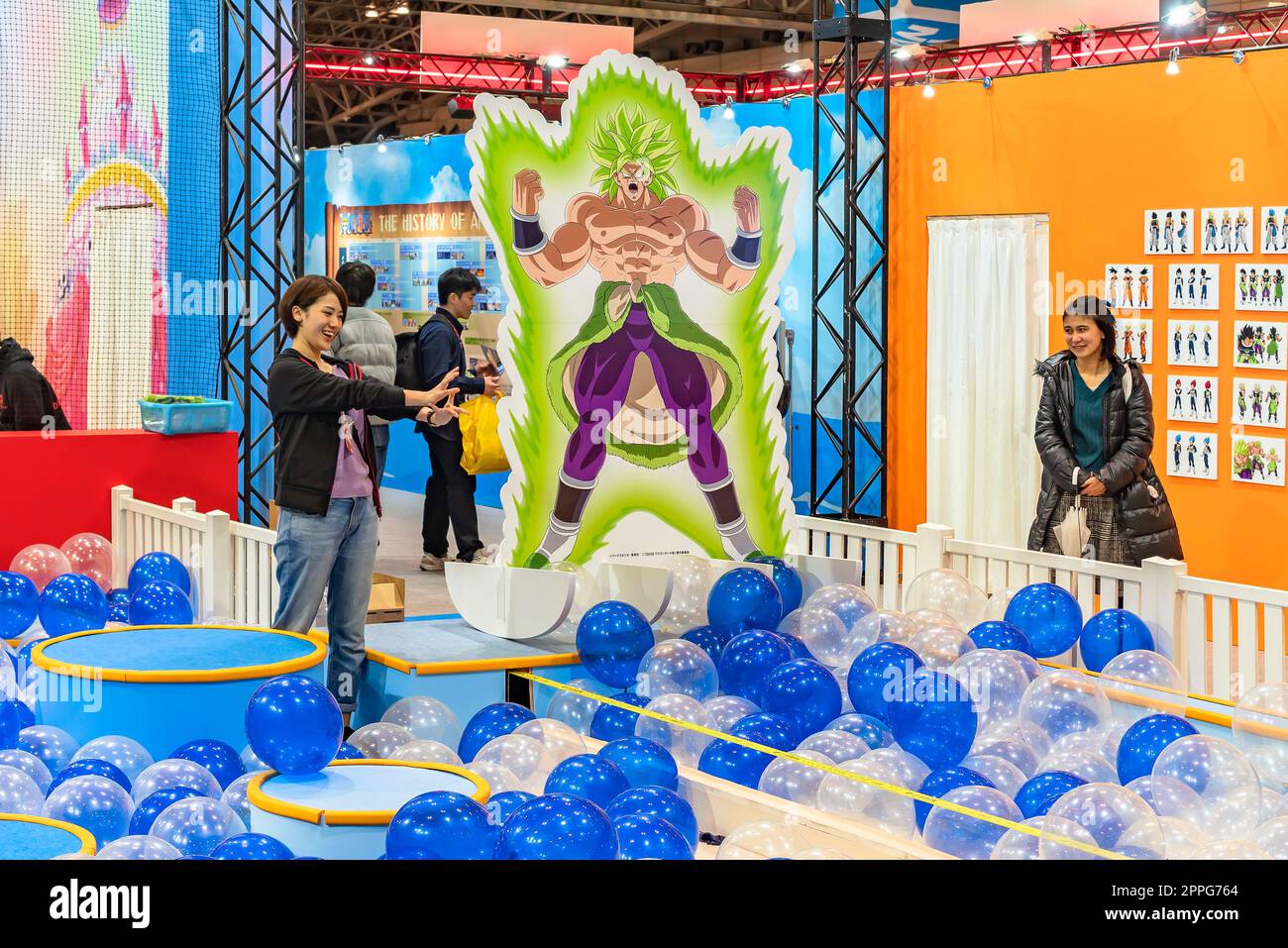chiba, japan - december 22 2018: Woman staff of the anime convention Jump Festa 19 entertaining the area dedicating to Dragon Ball decorated with a life sized standee of the character named Broly. Stock Photo