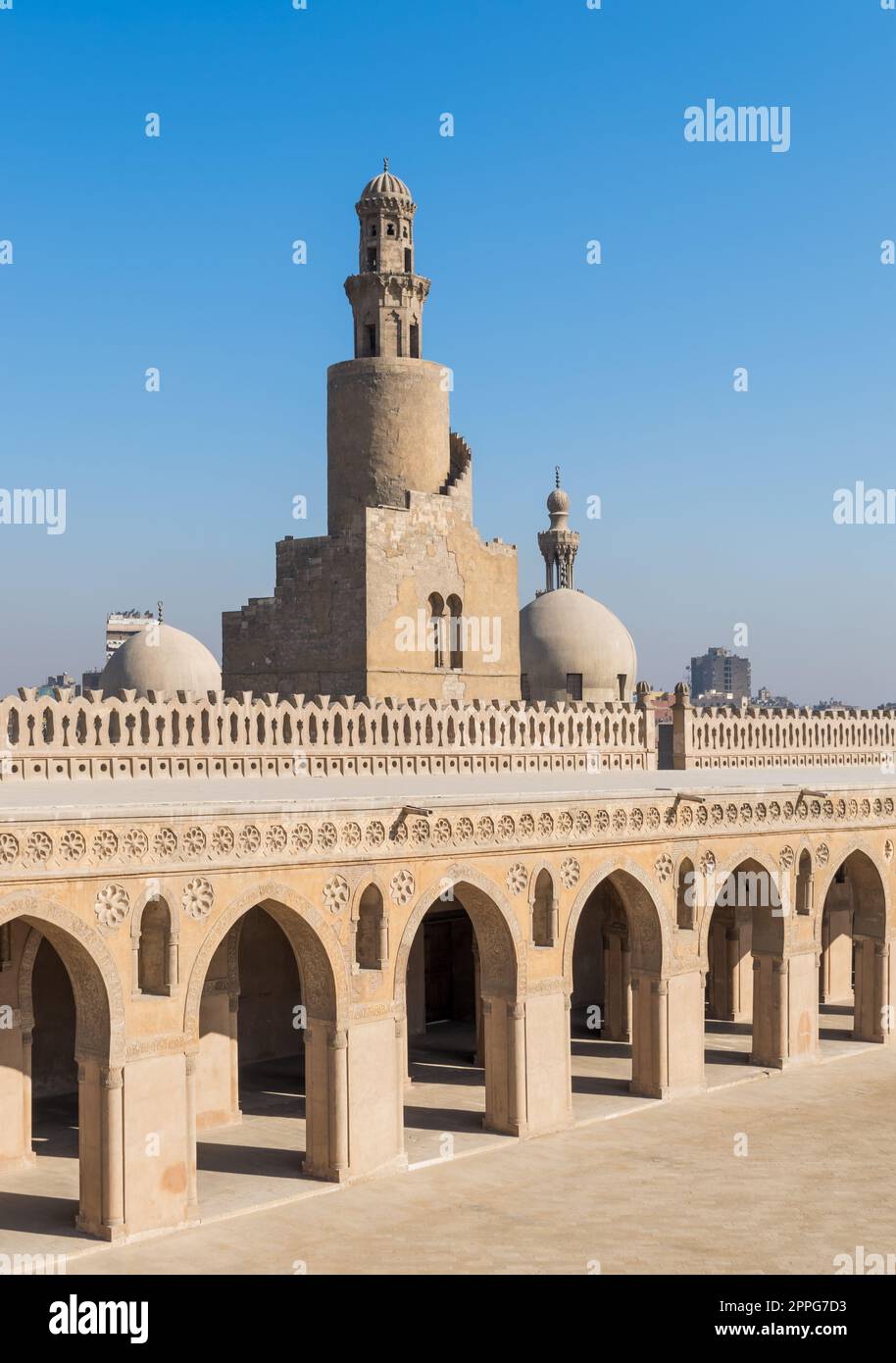 Minaret Ibn Tulun Mosque with helical outer staircase and dome of Amir Sarghatmish mosque, Cairo, Egypt Stock Photo