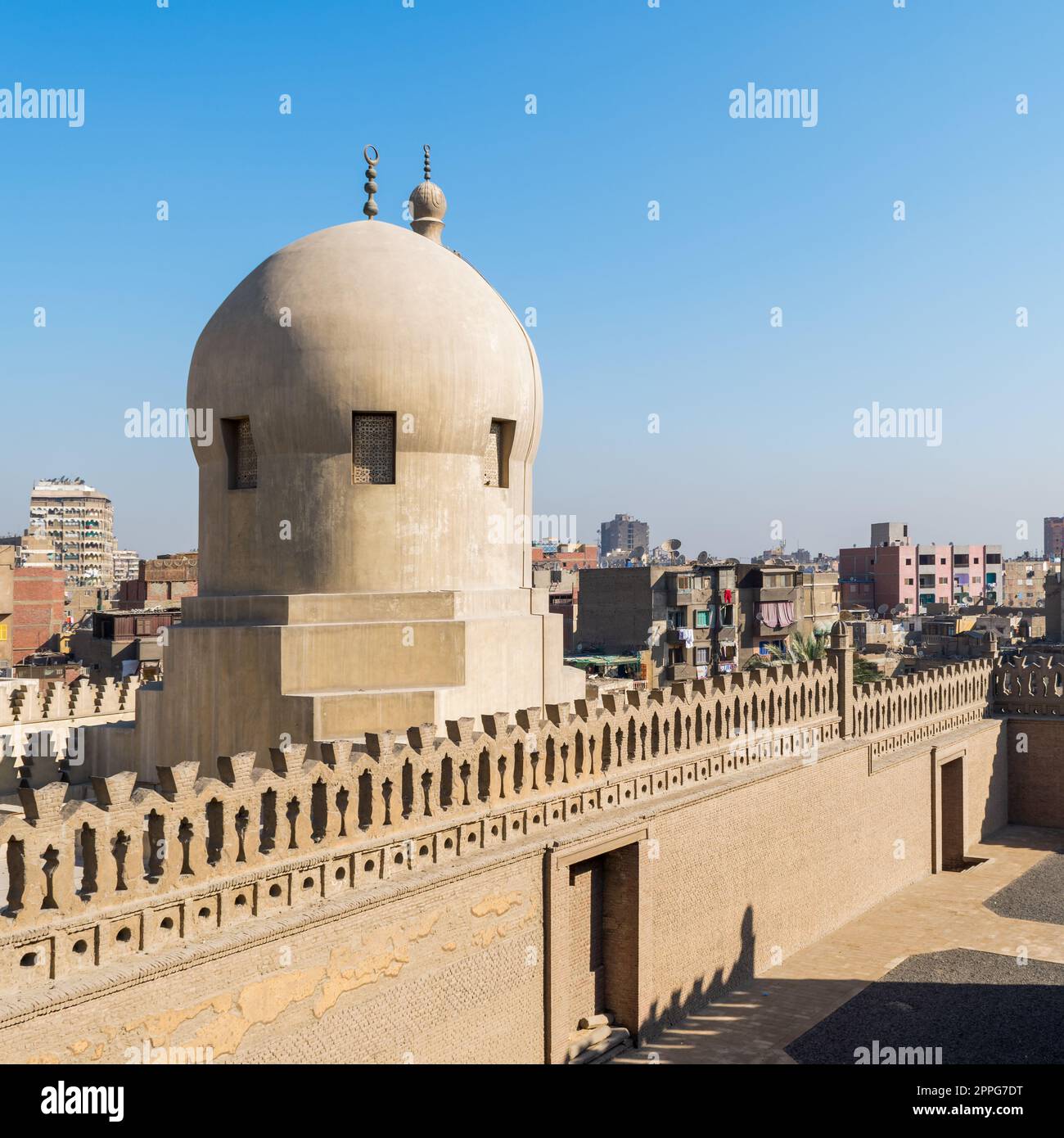 Fence of Ibn Tulun Mosque revealing dome of Amir Sarghatmish mosque, Cairo, Egypt Stock Photo