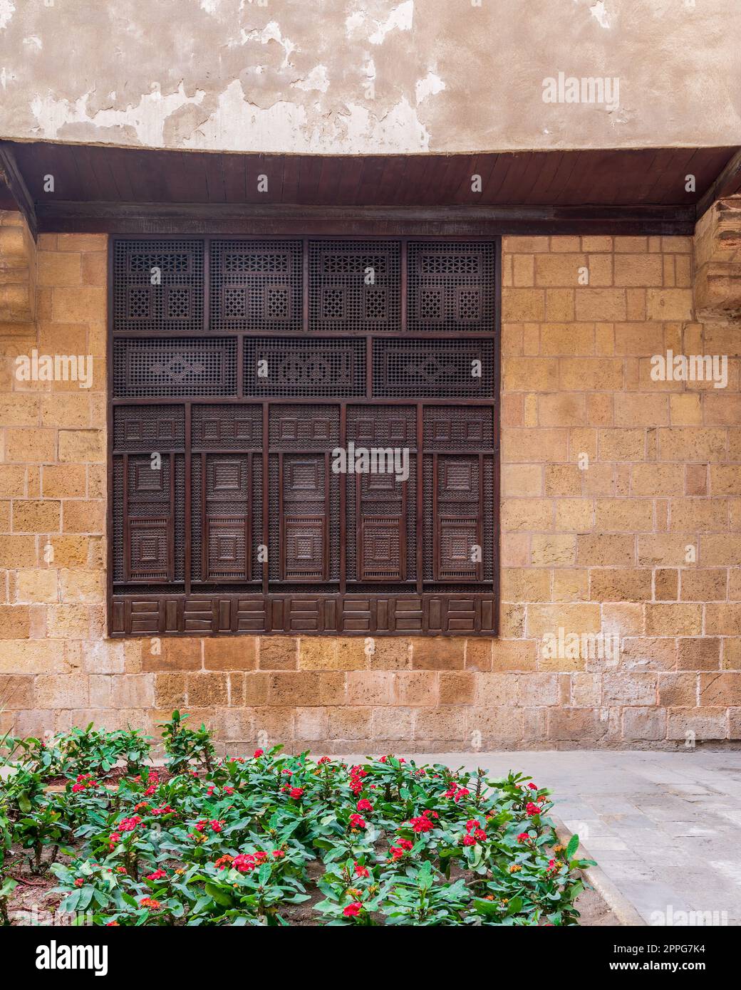 Wooden arabesque window, Mashrabiya, in exterior stone bricks wall of ottoman old historic building Stock Photo