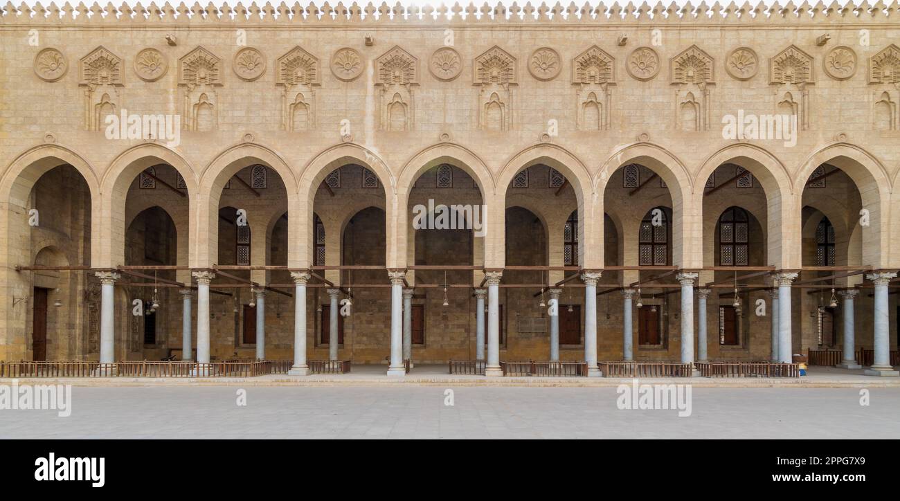 Arched corridor surrounding the courtyard of public historic Moaayad mosque, Cairo, Egypt Stock Photo