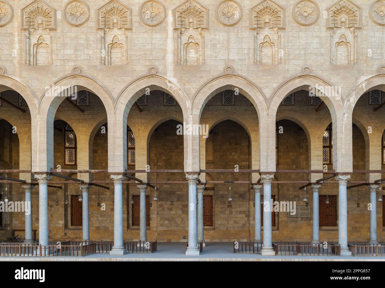 Arched corridor surrounding the courtyard of public historic Moaayad mosque, Cairo, Egypt Stock Photo