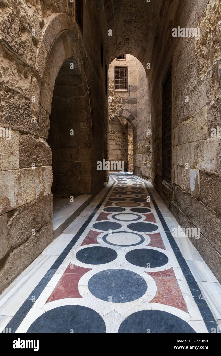 Vaulted passage leading to the Courtyard of Sultan Qalawun mosque with colorful marble floor, Cairo Stock Photo