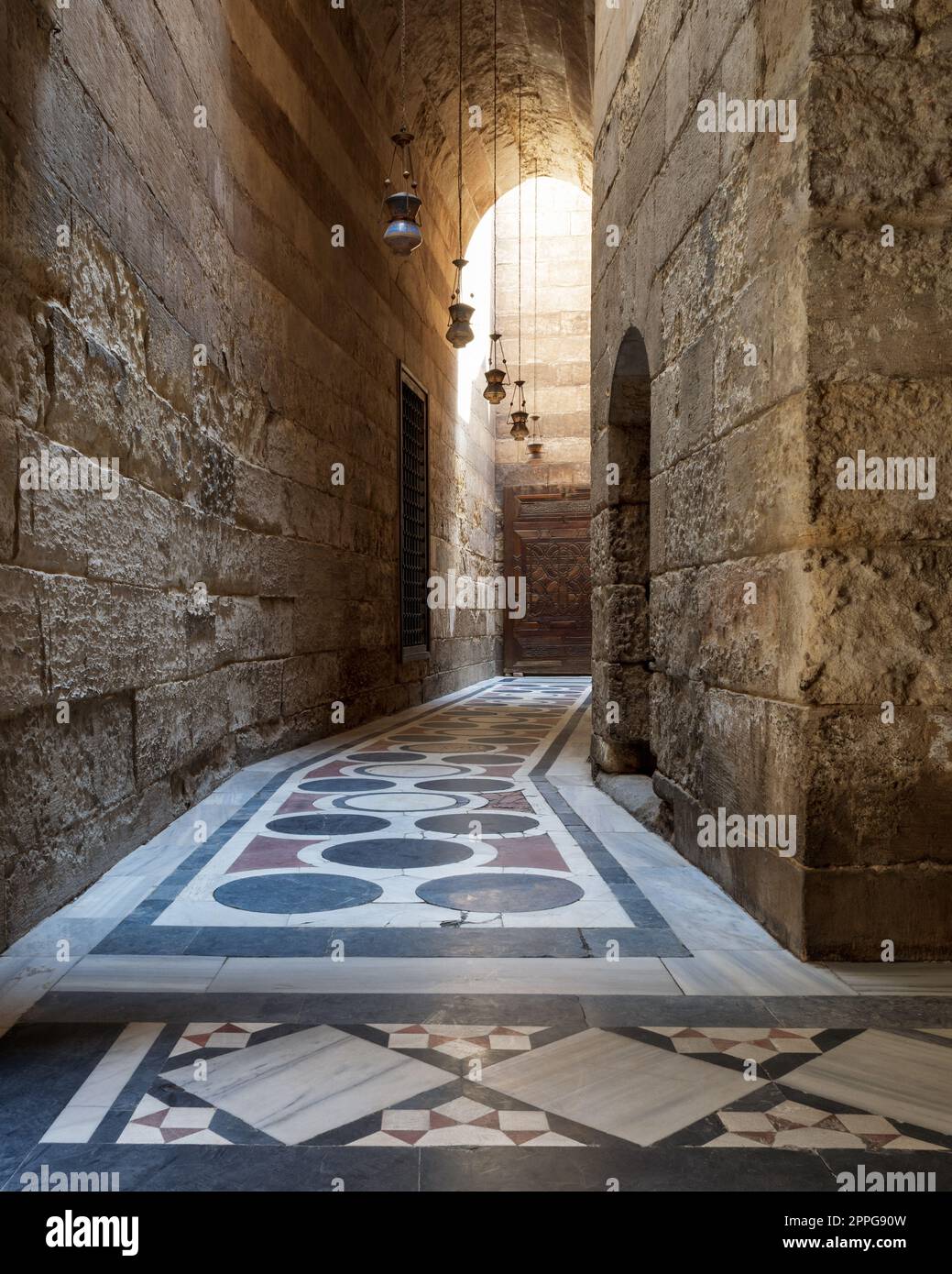 Vaulted passage leading to the Courtyard of Sultan Qalawun mosque with colorful marble floor, Cairo Stock Photo