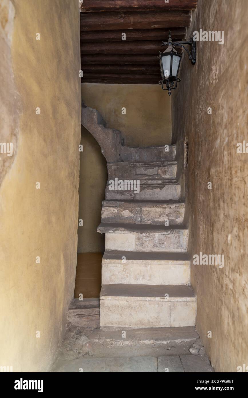 Day shot of old narrow stone staircase and wooden ceiling Stock Photo