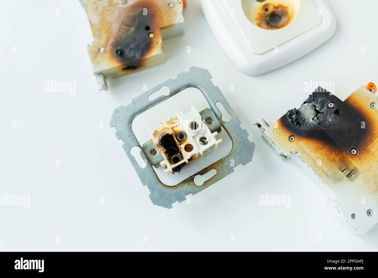 Electrical short circuit. Failure caused by burning wire and rosettes socket plug in house. Stock Photo