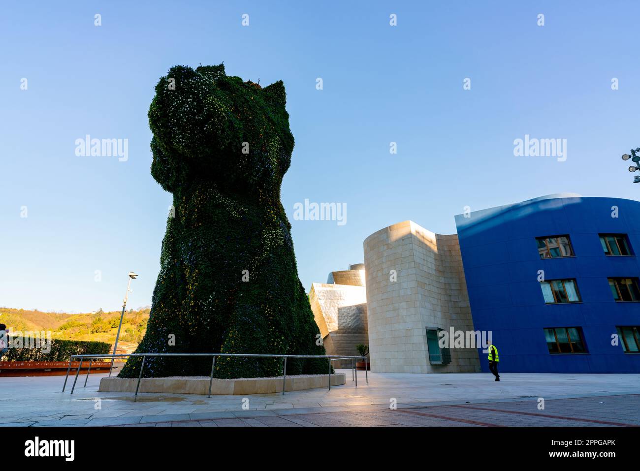 BILBAO, SPAIN-DECEMBER 18, 2021 : Puppy stands guard at Guggenheim Museum in Bilbao, Biscay, Basque Country, Spain. Landmarks. Dog sculpture of artist Jeff Koons. The Worldâ€™s largest flower sculpture. Stock Photo