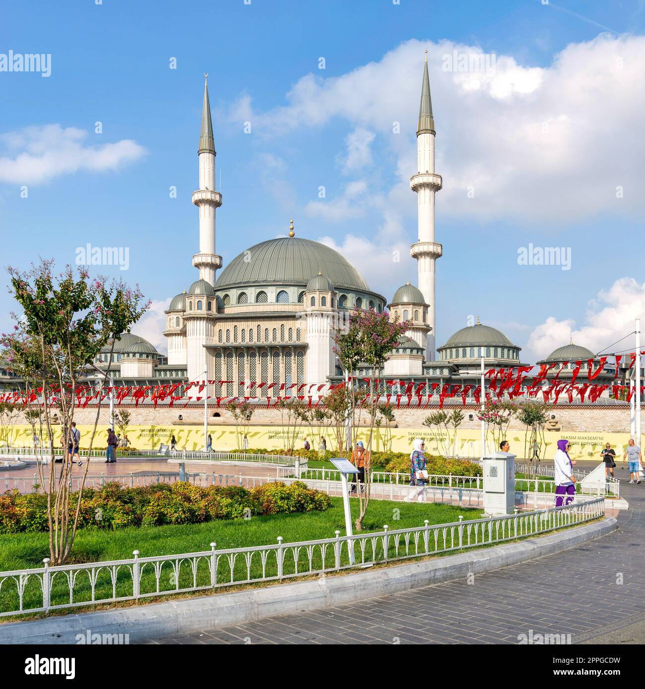 Tourists walking in front of Taksim Mosque, at Taksim Square, Istanbul, Turkey Stock Photo