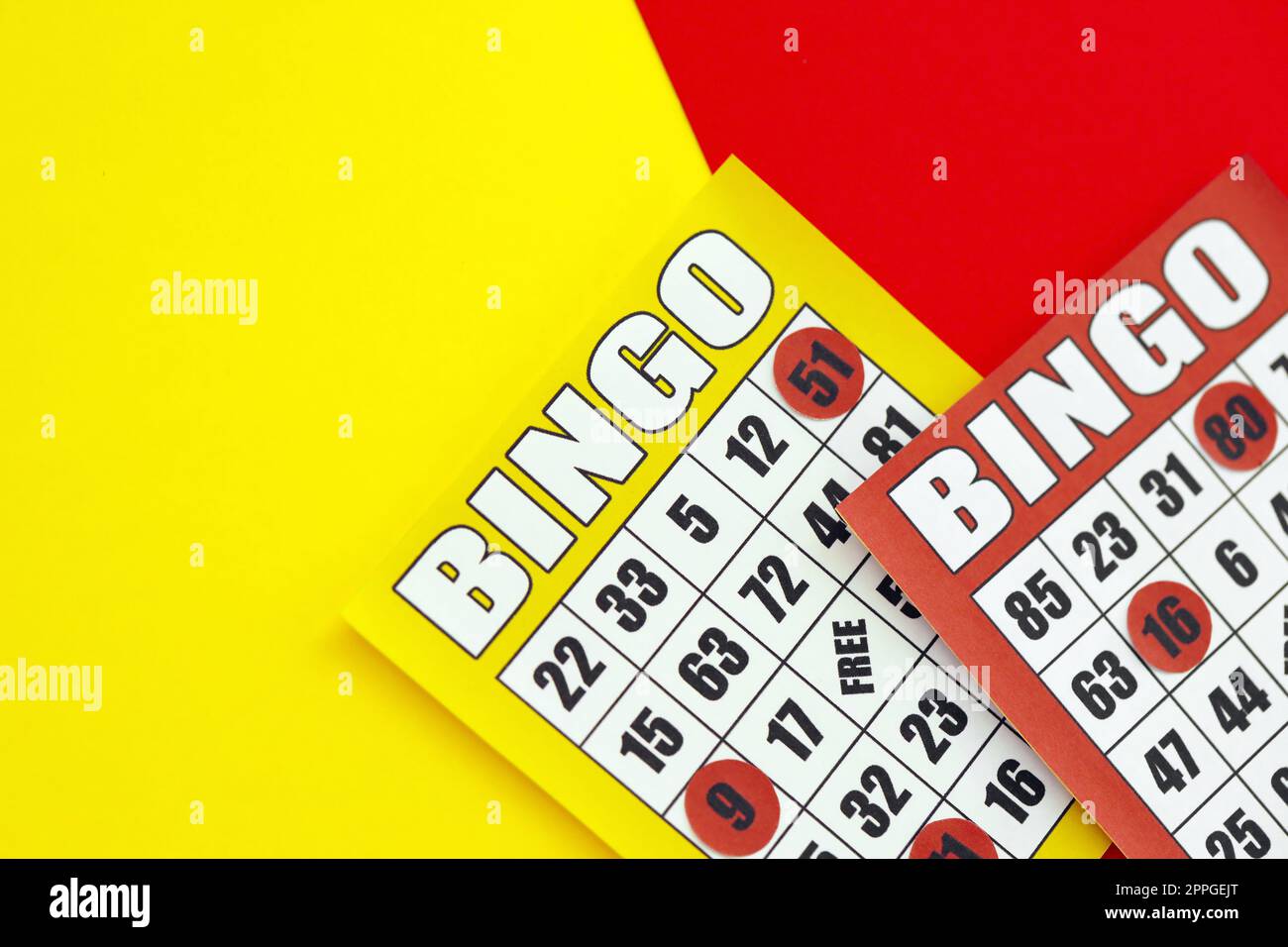 Yellow and red bingo boards or playing cards for winning chips. Classic US or canadian five to five bingo cards on bright background Stock Photo