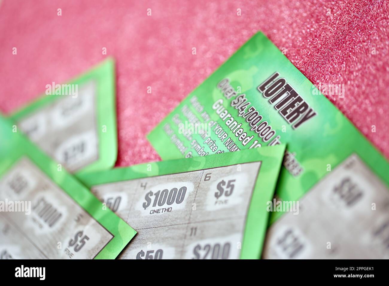 Close up view of green lottery scratch cards. Many used fake instant lottery tickets with gambling results. Gambling addiction Stock Photo