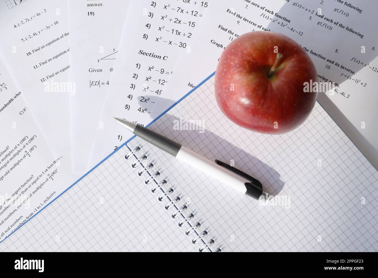 Handwriting of mathematics quadratic equation on examination, practice, quiz or test in maths class. Solving exponential equations concept. Stock Photo