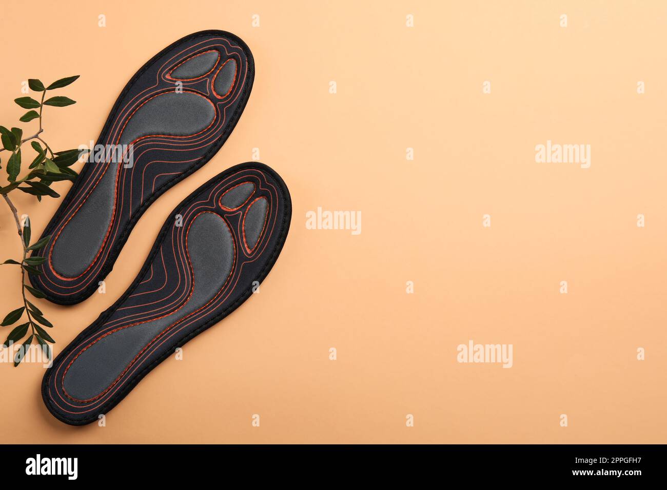 Leaf Pattern Insole Pair of orthopedic insoles and leaves on pale orange background, top ...
