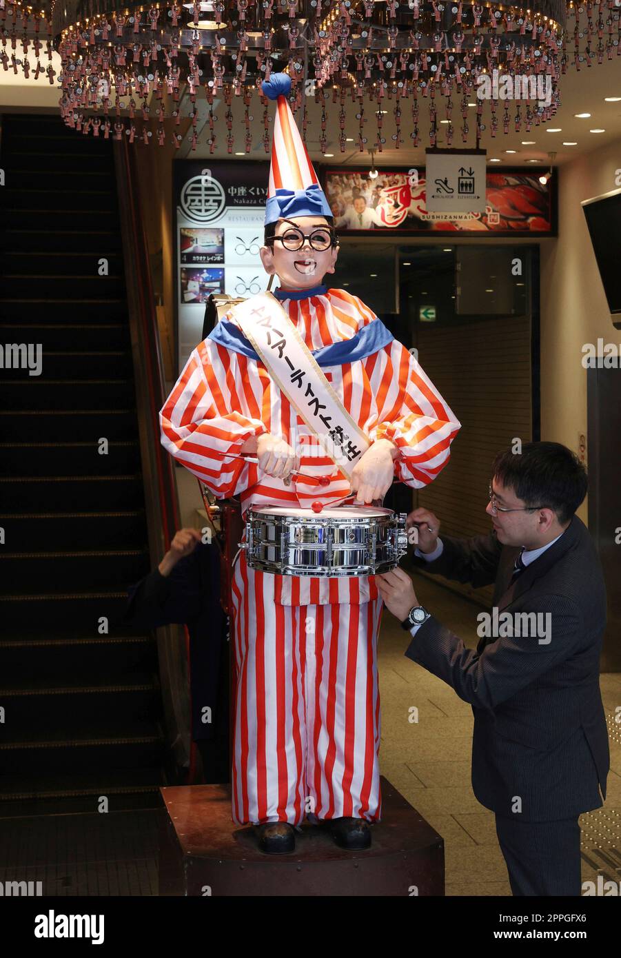 Kuidaore Taro, a mechanical drum-playing clown receives a drum made by ...