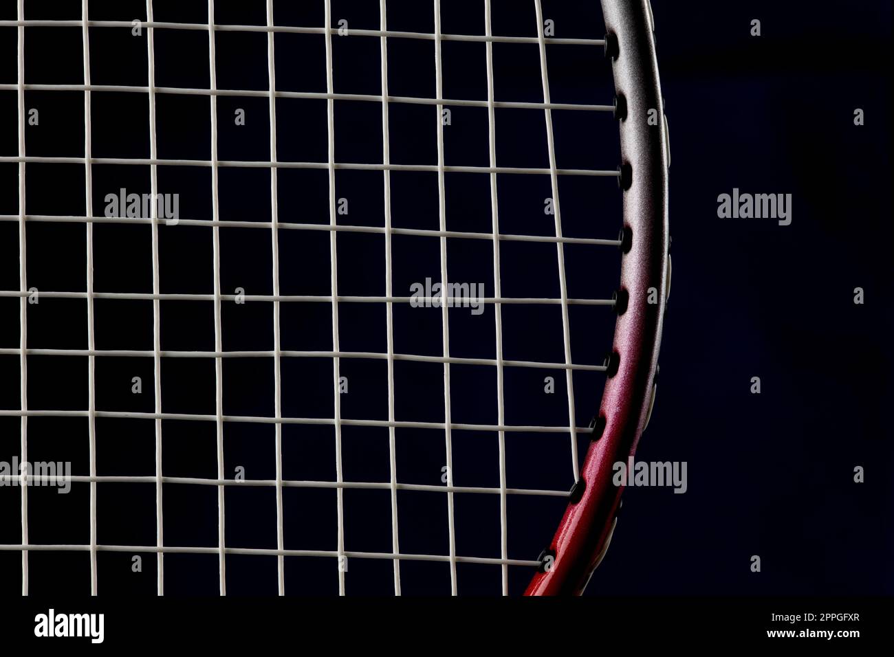 Badminton racket frame and strings on a dark blue background Stock Photo