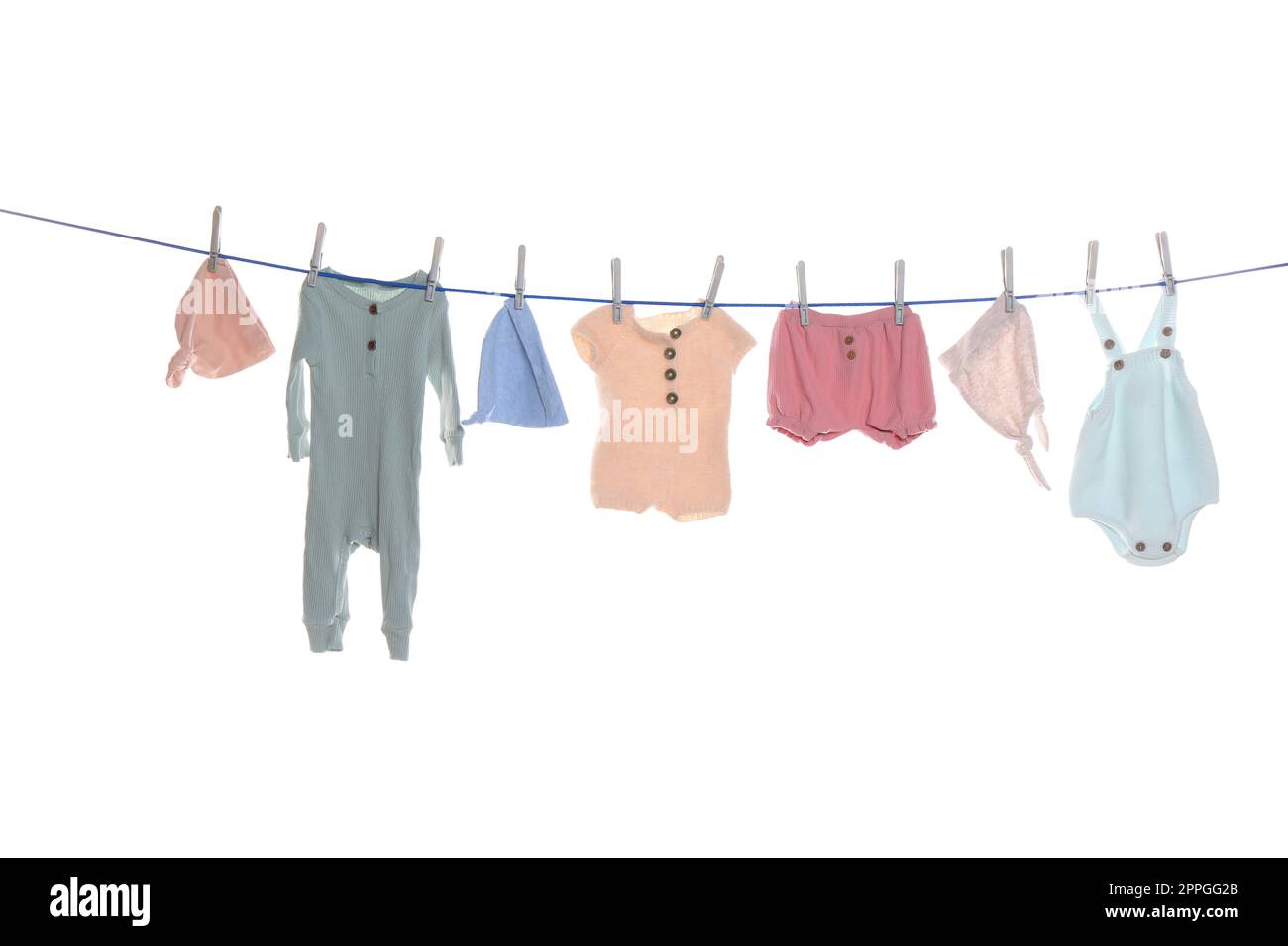 Colorful baby clothes drying on laundry line against white background