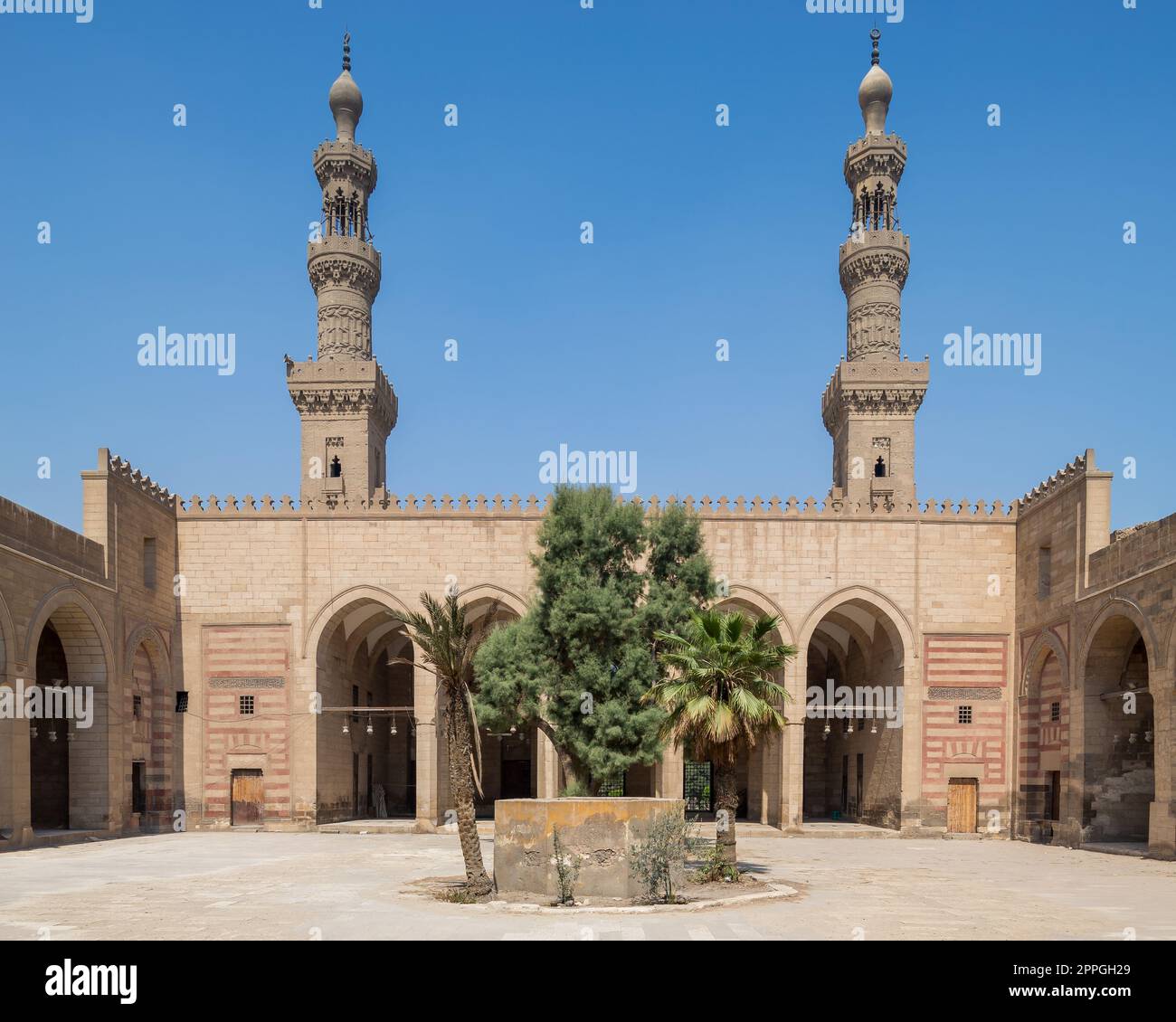 Courtyard of al Nasir Faraj ibn Barquq public historical mosque with two minarets, Cairo, Egypt Stock Photo