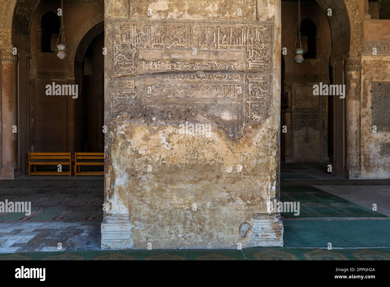 Ornate engraved stone wall with ruined floral patterns at Ibn Tulun Mosque, Cairo, Egypt Stock Photo