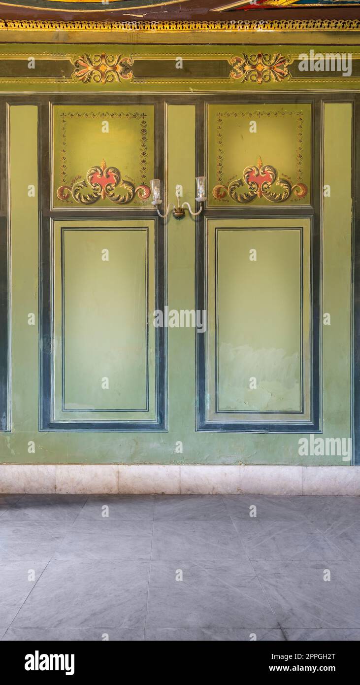 Beautiful elegant carved frames on green wall with ornate border with