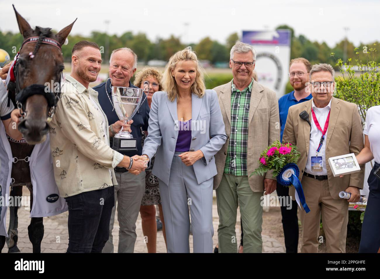 Veronica Ferres ( actress ) and Andreas Haase ( managing director of the Berlin Trotting Association ) at the Super Trot Cup 2022 to the owner Remon Hendriks the winner's cup at the trotting track Mariendorf. Stock Photo