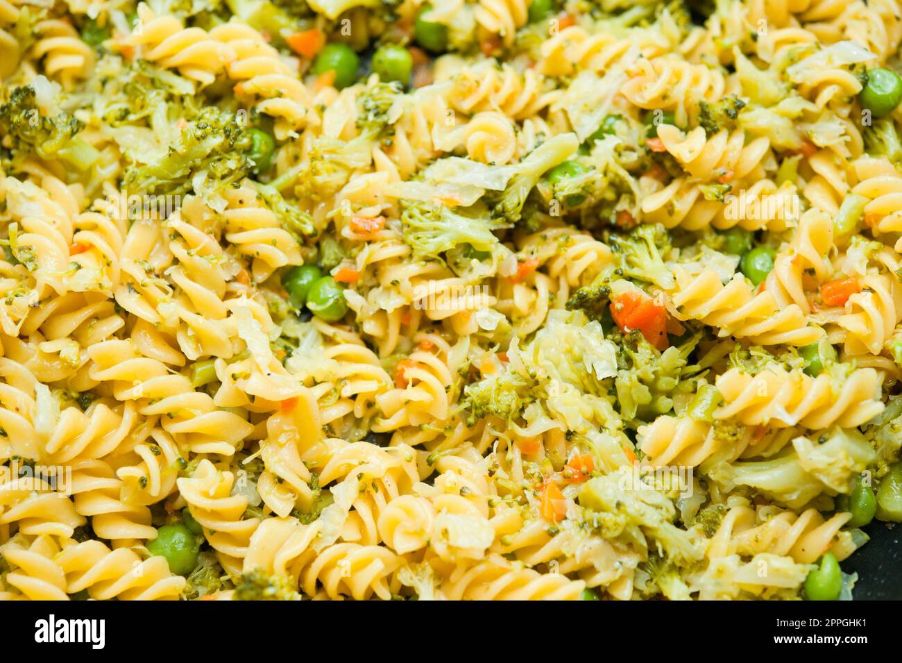 pan of pasta with carrots, peas and broccoli Stock Photo Alamy