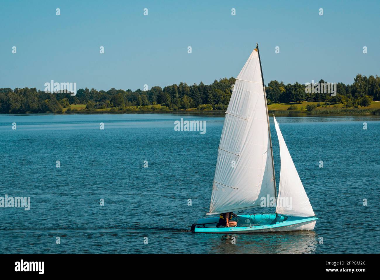 Sailing boat on a calm lake Stock Photo - Alamy
