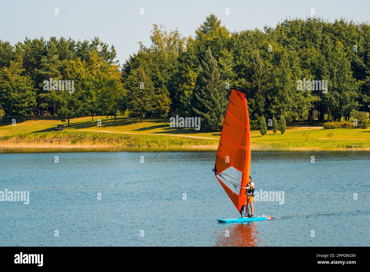 Surfer sailing with sail board in the water Stock Photo Alamy