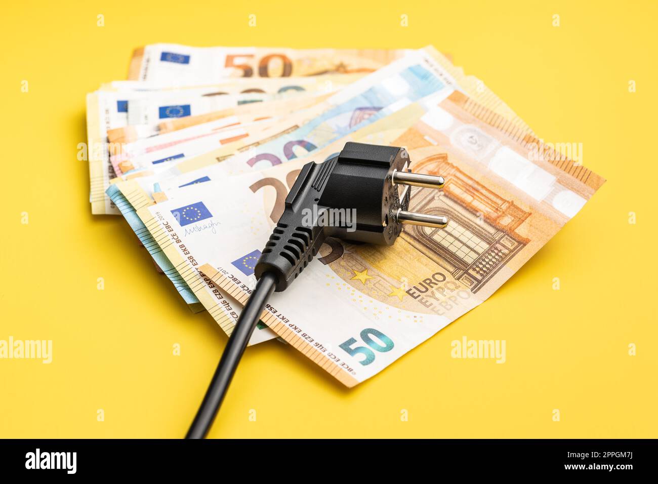 Electric plug and euro money. Concept of increasing electricity prices. Stock Photo