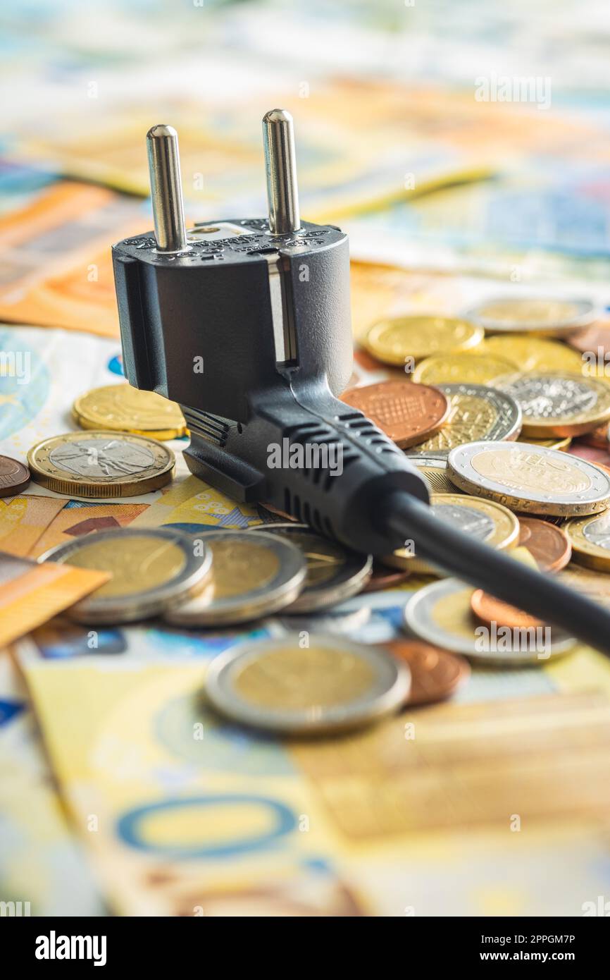 Electric plug and euro money. Concept of increasing electricity prices. Stock Photo