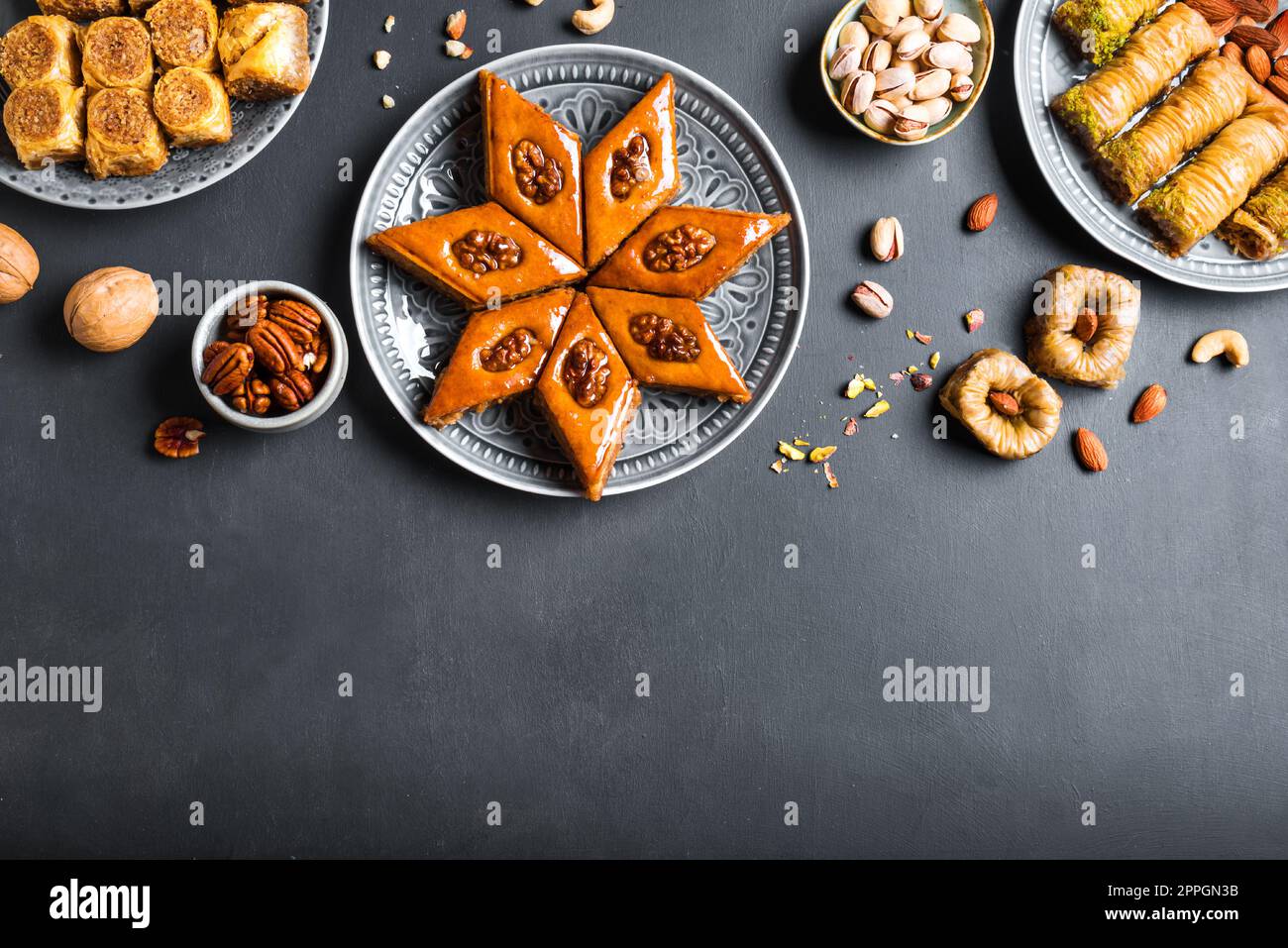 Arabian Baklava with nuts and honey on dark background, copy space, top view. Ramadan dessert