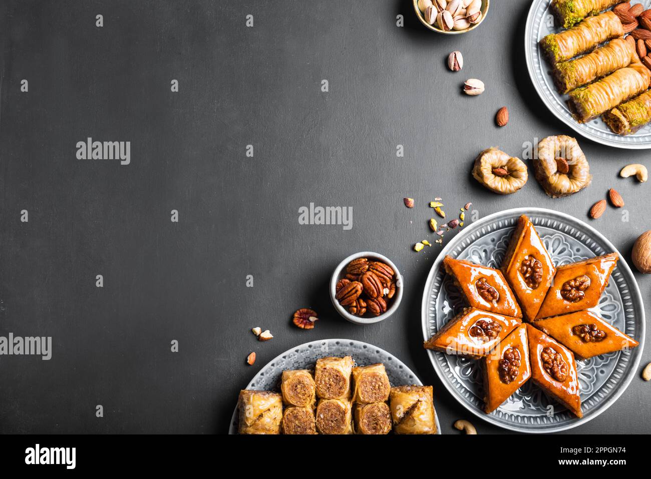 Arabian Baklava with nuts and honey on dark background, copy space, top view. Ramadan dessert