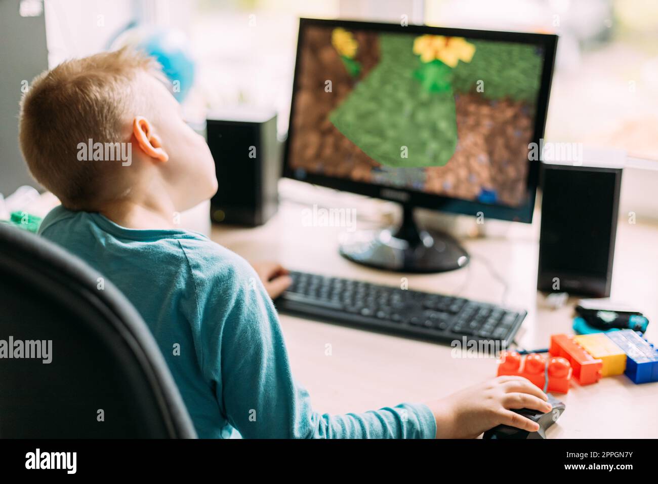 Little Caucasian Boy Playing In Computer Games Stock Photo