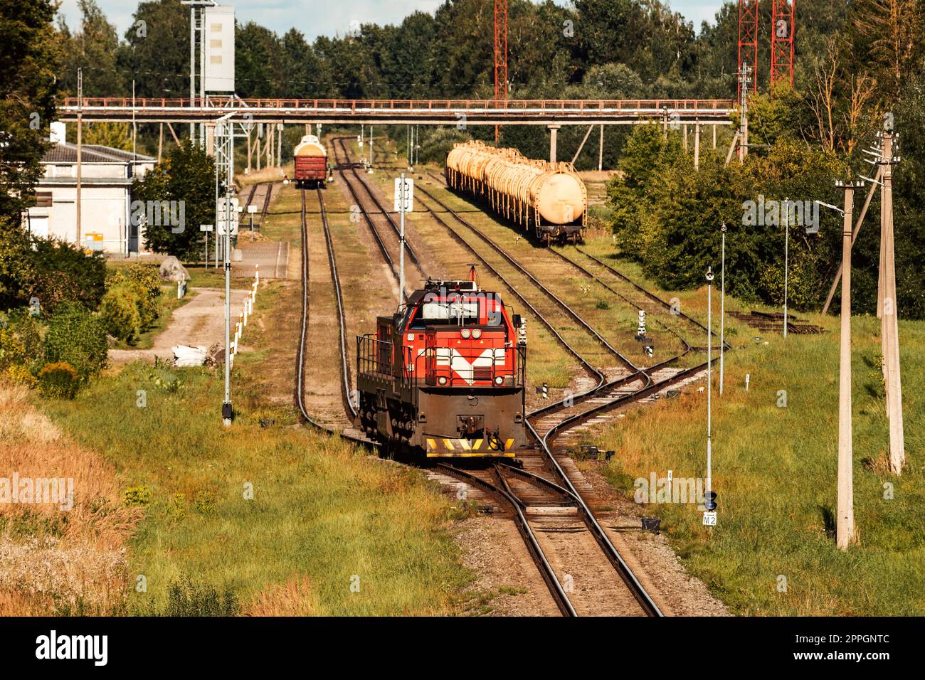 Lone shunting locomotive in red color at marshalling yard Stock Photo