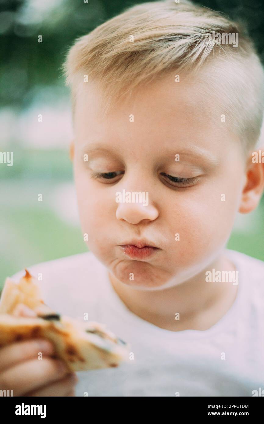 Little Boy Eating Pizza In Cafe In Summer Day Stock Photo Alamy