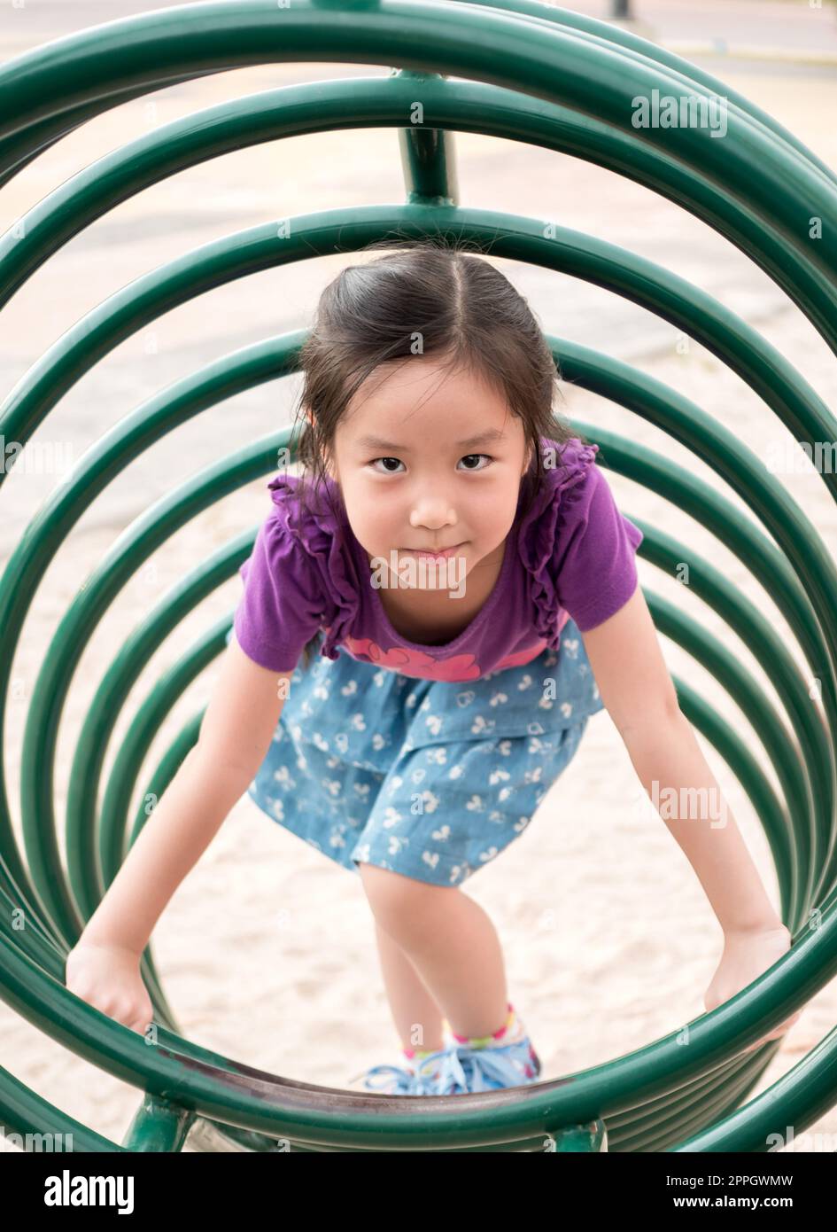 Happy kid, asian baby child playing on playground, climb the playground equipment, circle shape Stock Photo